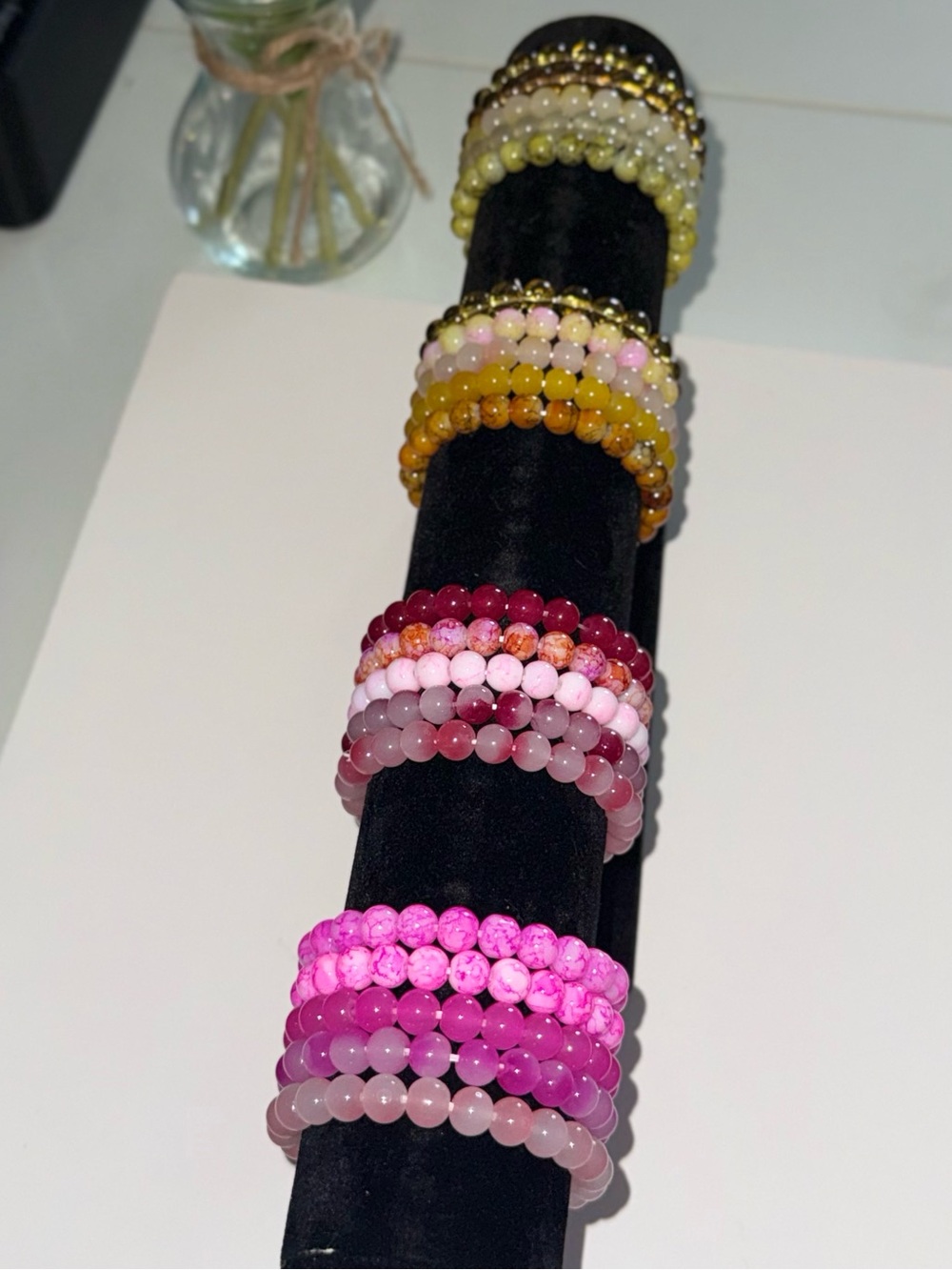 Multi-colored beaded bracelets with pink, red, yellow, blue, black